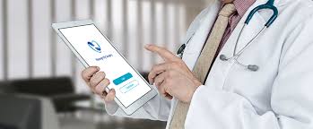 doctor holding tablet with manage my surgery app on display