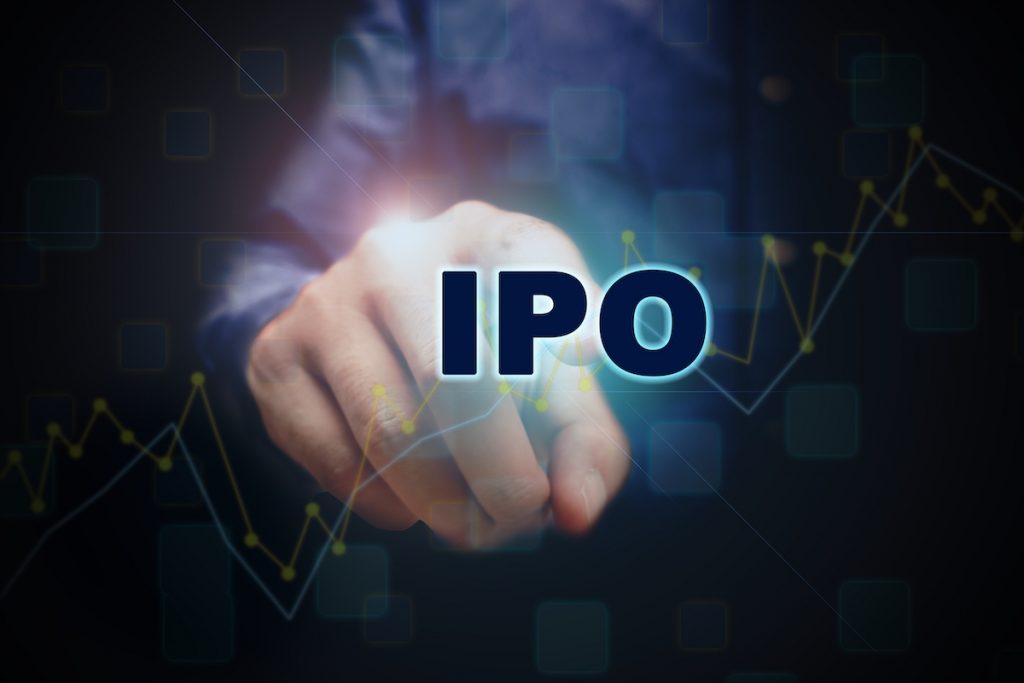 Close up finger pointing into the ipo text with initial public offering concept.